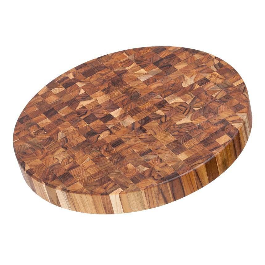 Round teak end-grain cutting board with a cross-cut block surface
